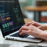 Person writing content on a laptop with cause-related imagery